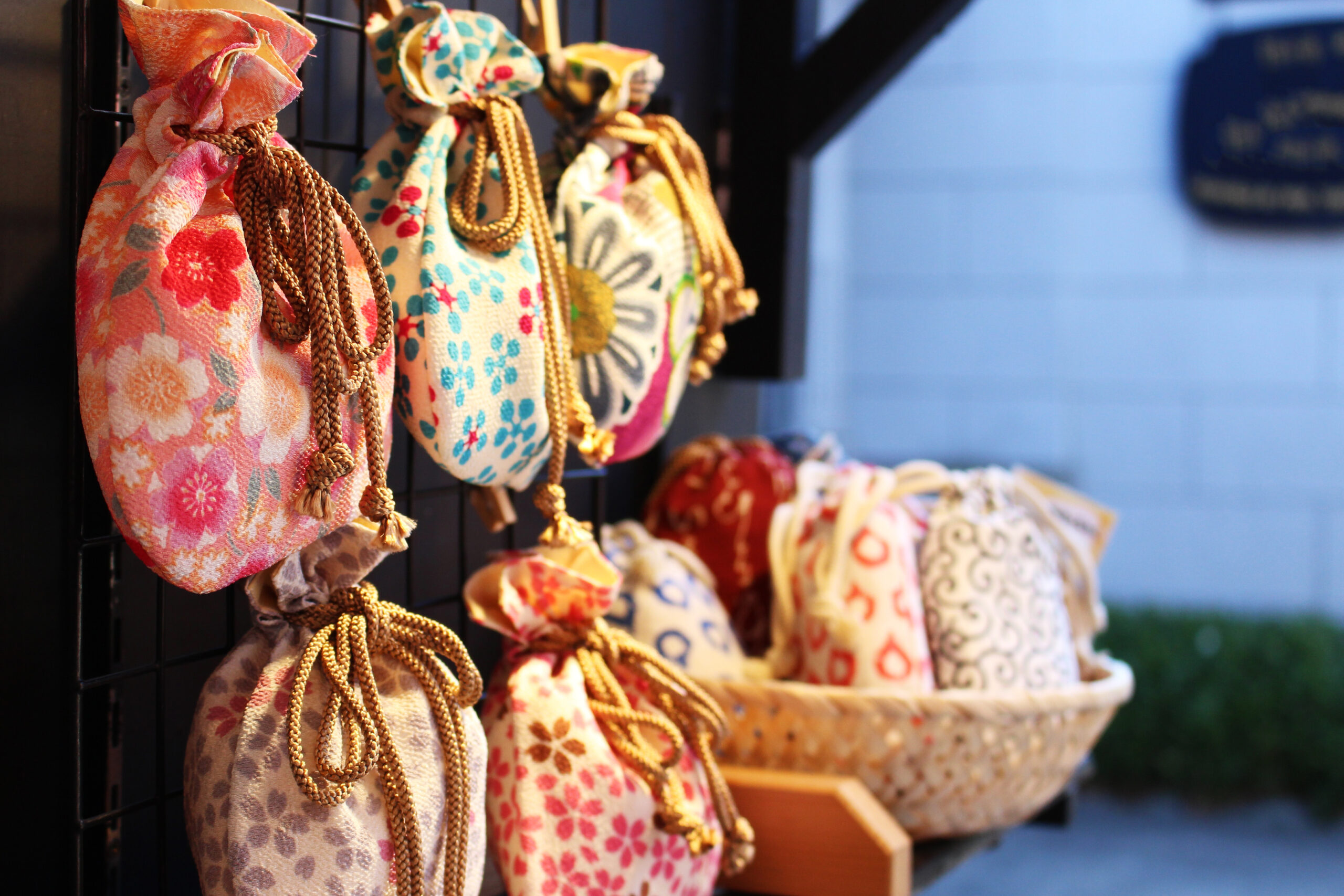 Rows of floral-patterned drawstring bags hanging on a display rack.